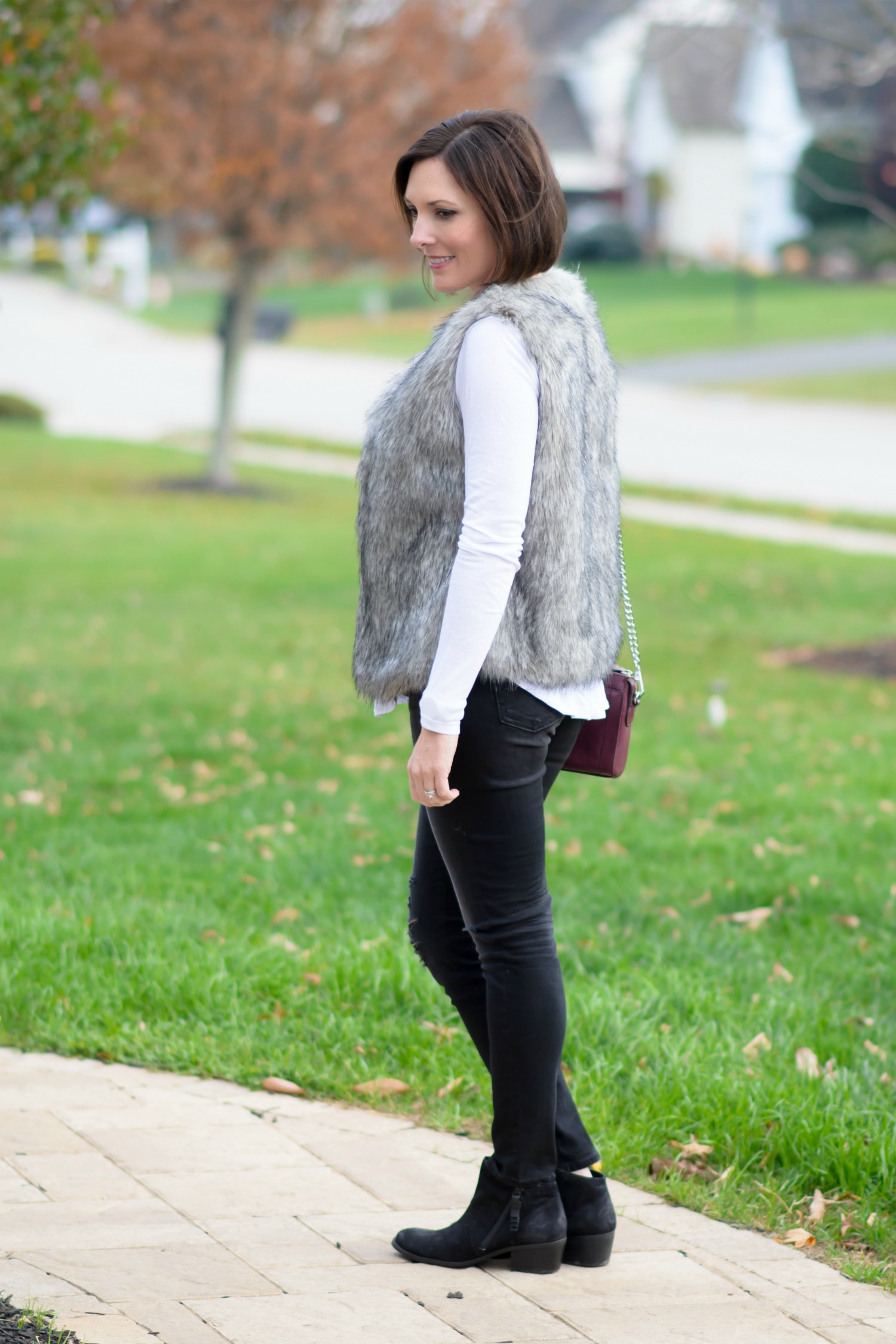 Winter Outfit Ideas: Fur Vest with Distressed Jeans and Long Sleeve Tee