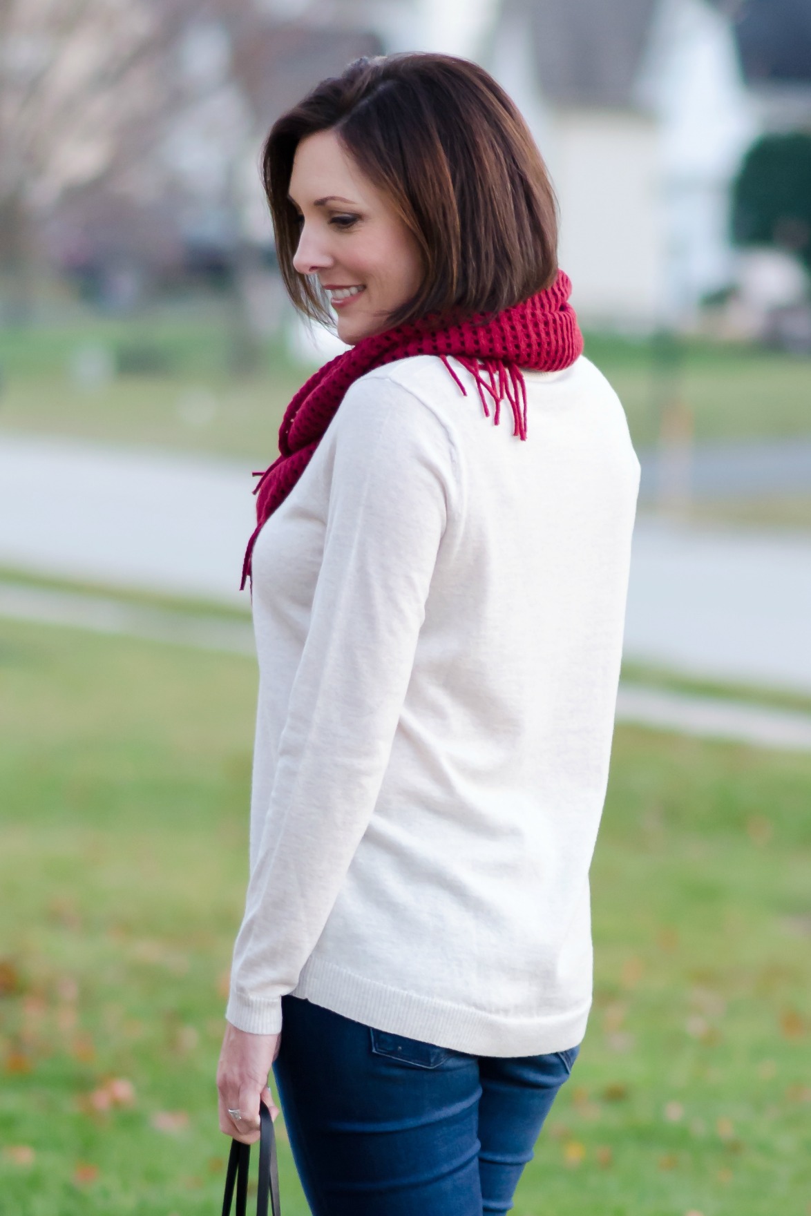 Casual Winter Outfit: Red Fringe Scarf, Relaxed Fit Oatmeal Sweater, Cropped Skinnies and Converse