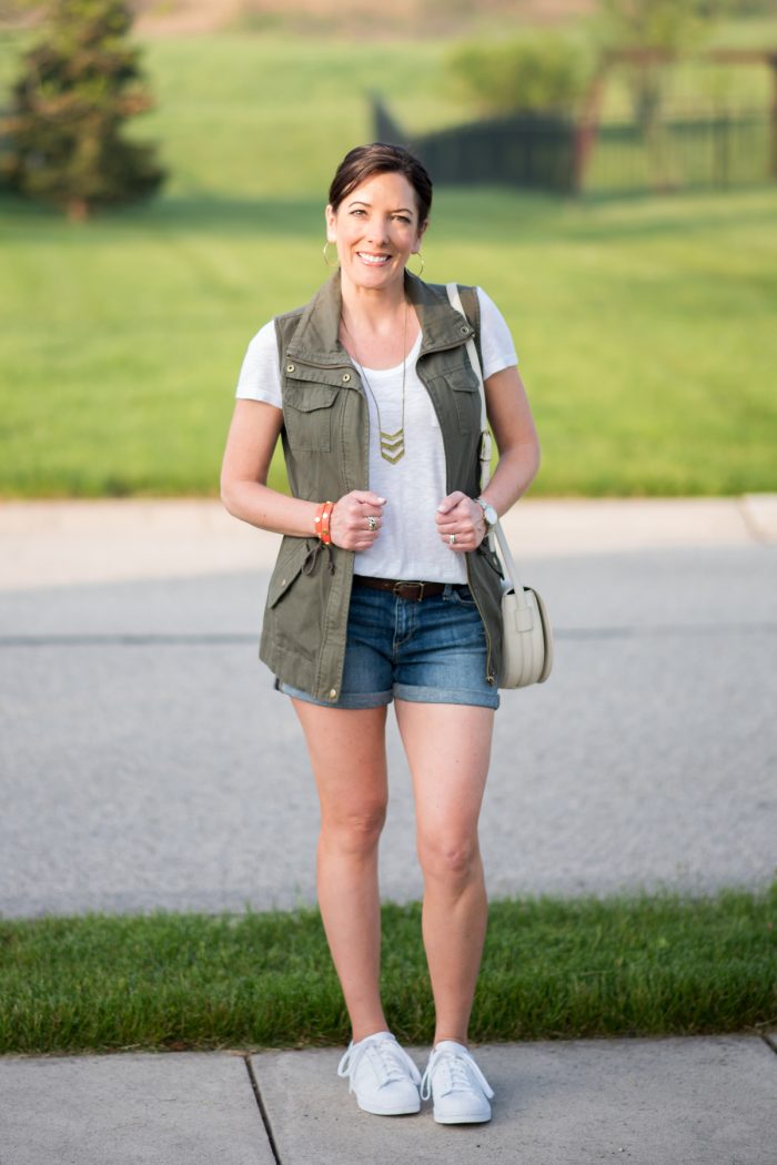 Jo-Lynne Shane wearing Utility Vest and Denim Shorts with white tee and Adidas Superstars