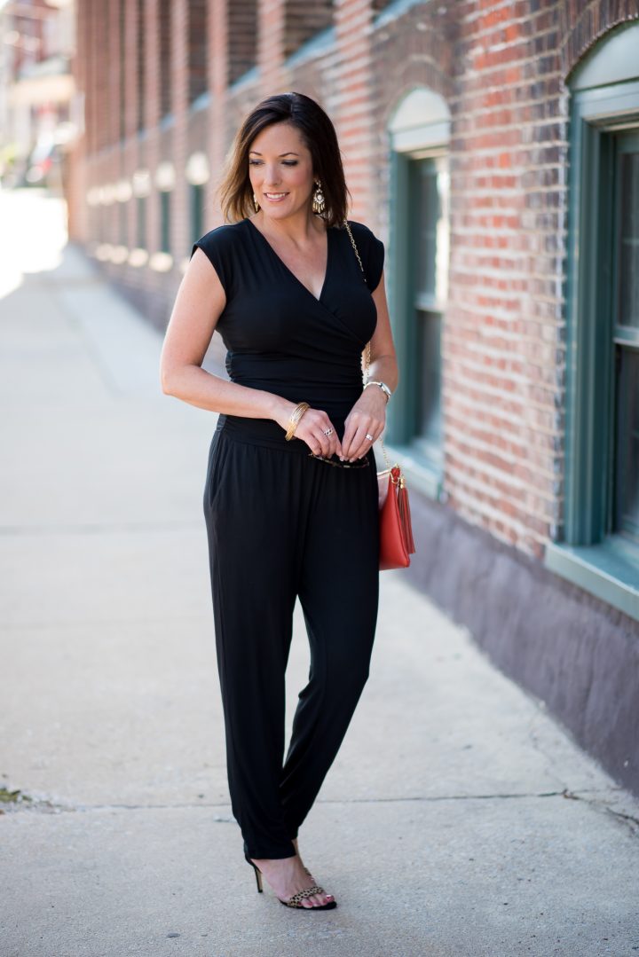How to Wear a Jumpsuit: An all black jumpsuit is stunning with leopard sandals and an orange clutch! Fashion for Women Over 40