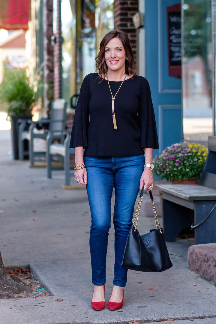 Red shoes are a big trend right now, and today I'm styling a classy fall date night look with red suede pumps and a gorgeous black pleated sleeve top.