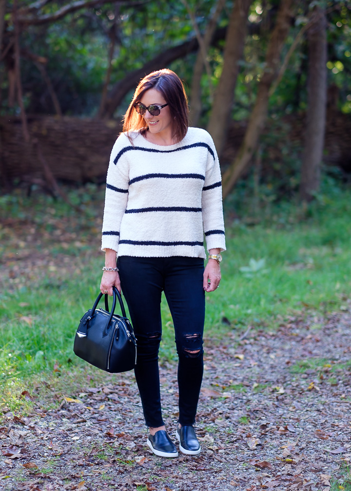 Jo-Lynne Shane wearing a striped chenille sweater with slip-on sneakers and distressed black jeans.