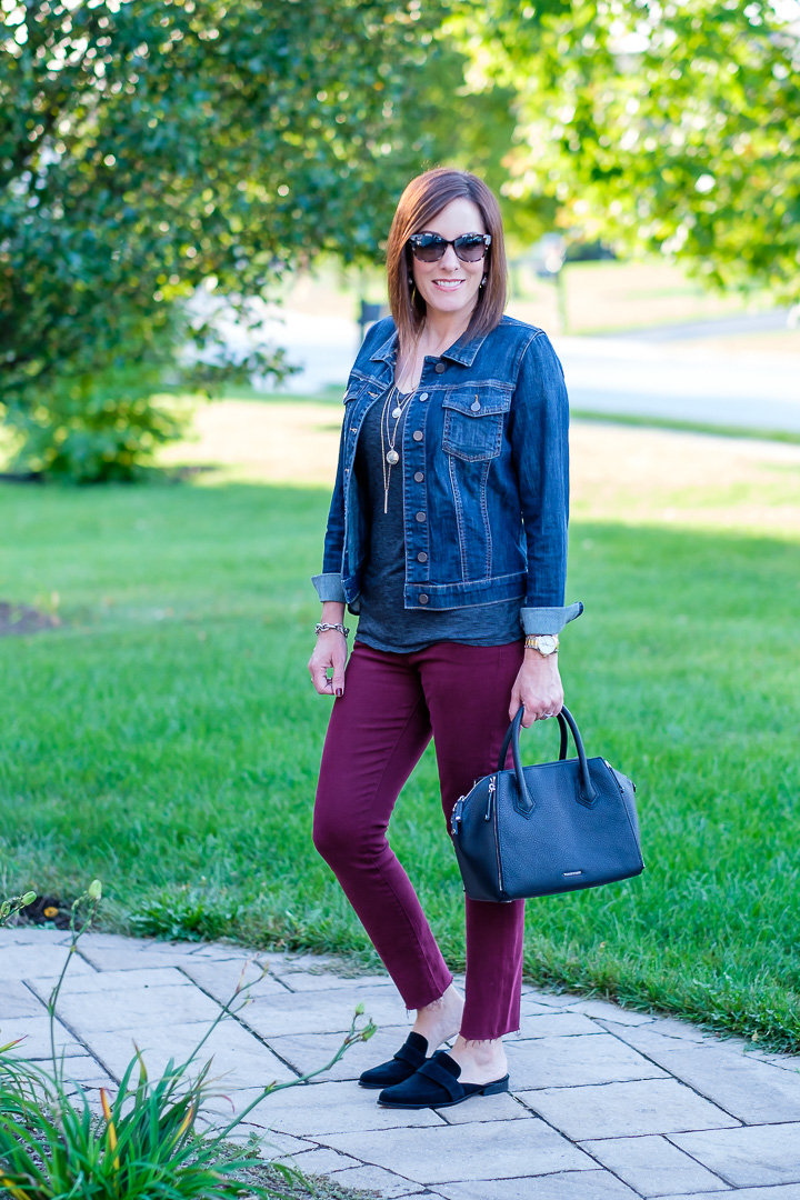 Jo-Lynne Shane styling burgundy jeans with a denim jacket and slide loafers