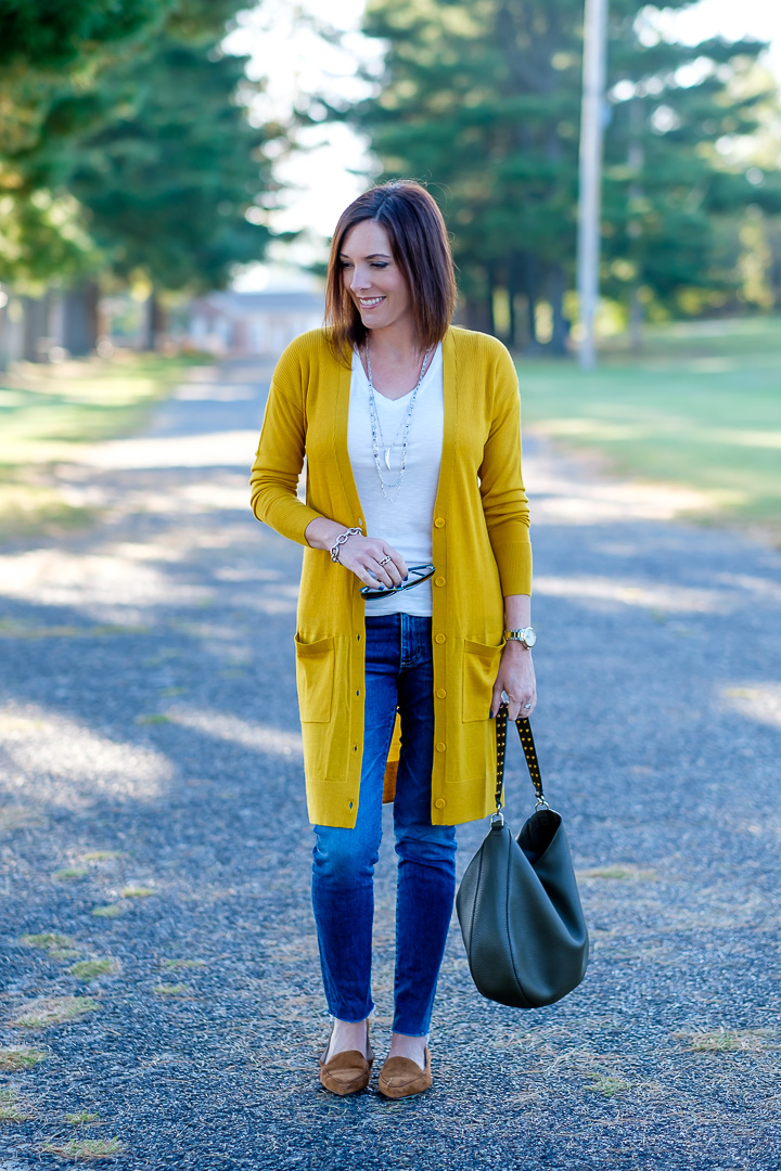 Jo-Lynne Shane wearing a mustard cardigan outfit with moss green bag and cognac loafers.