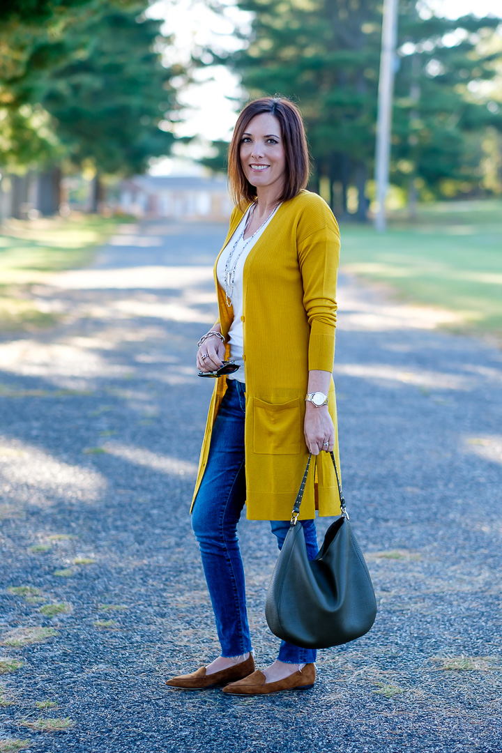 Jo-Lynne Shane wearing a mustard cardigan outfit with moss green bag and cognac loafers. #falloutfit #mustardcardigan
