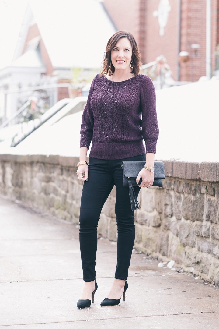New Year's Eve party outfit with plum sequined pullover, black jeans, and suede d'orsay pumps