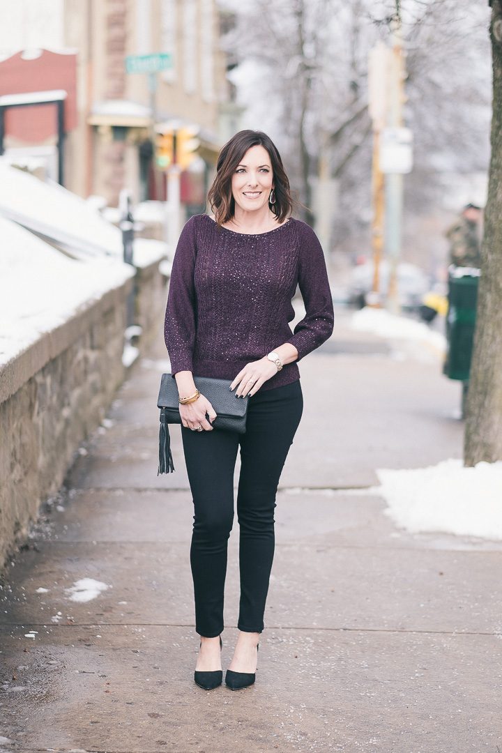 New Year's Eve party outfit with plum sequined pullover, black jeans, and suede d'orsay pumps