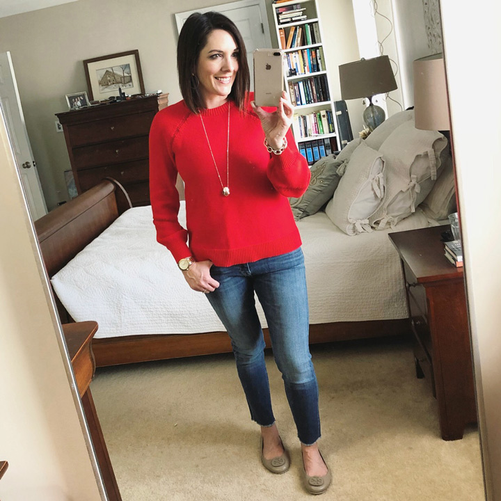 red sweater with blue skinnies and ballet flats