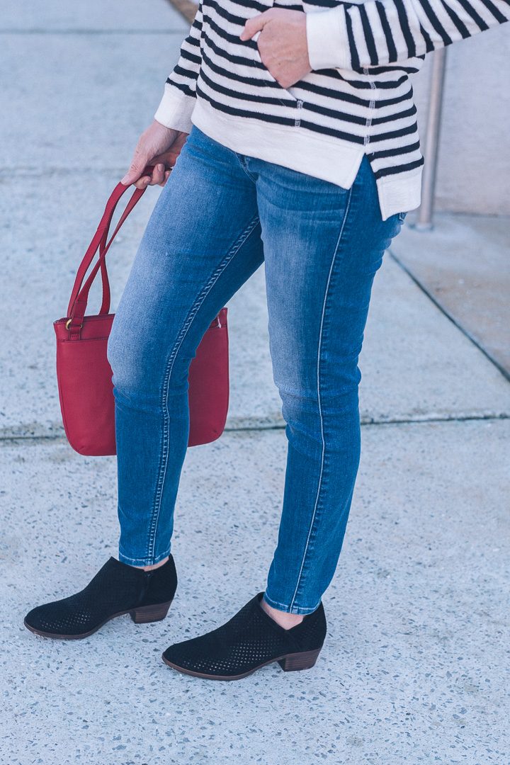 Sharing a spring transition outfit in partnership with T.J.Maxx! Striped hoodie, mid-wash skinny jeans, and black perforated ankle boots.