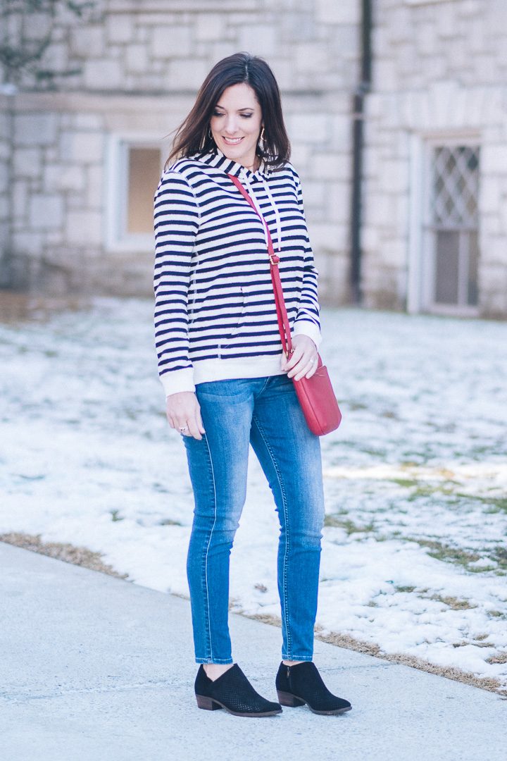 Sharing a spring transition outfit in partnership with T.J.Maxx! Striped hoodie, mid-wash skinny jeans, and black perforated ankle boots.