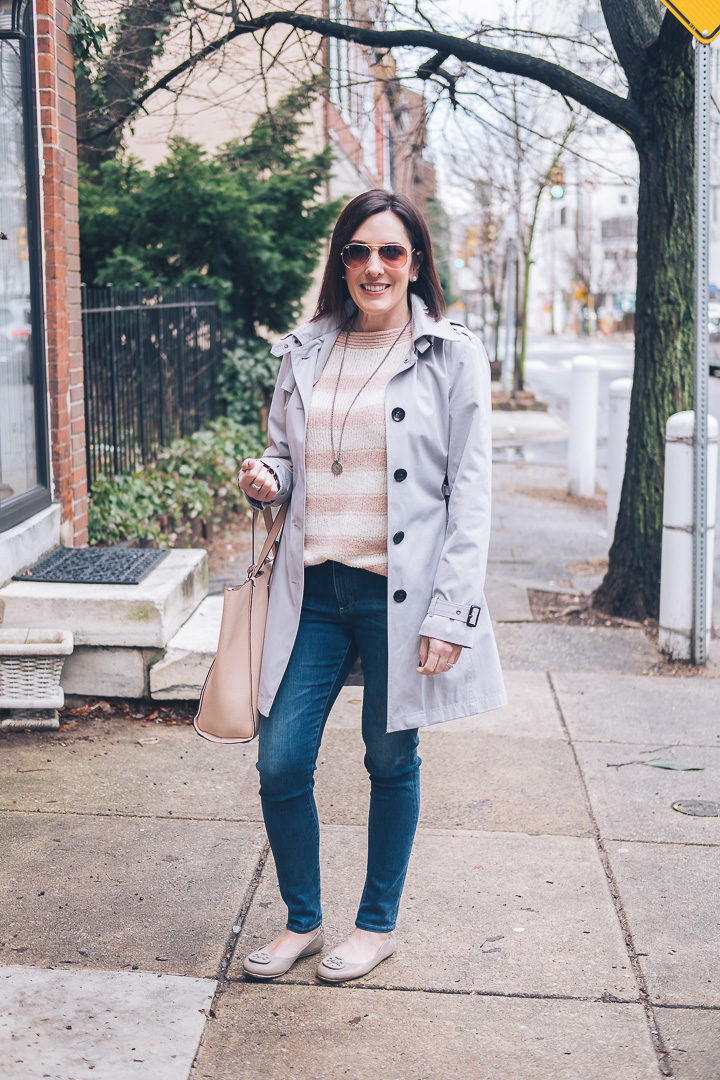 Casual spring outfit featuring Loft striped boatneck sweater, AG middi ankle jeans, Tory Burch Minnie travel flats in French Grey, J.Crew Signet Tote Bag in Soft Blossom, and Michael Kors Core Trench Coat #springfashion