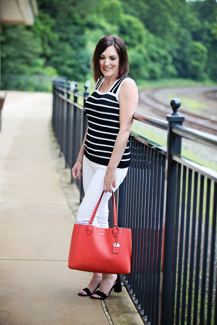 Striped Sweater Tank Outfit: Jo-Lynne Shane wearing Loft striped sweater tank with white Paige Verdugo ankle skinny jeans, black suede Sam Edelman Odila sandals, and kate spade new york Carter Street Leather Tyler Tote in Picnic Red/Gold.