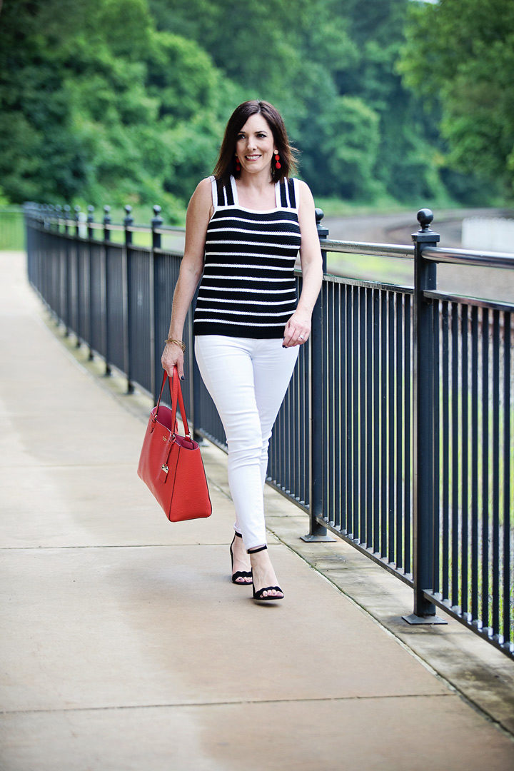 Striped Sweater Tank Outfit: Jo-Lynne Shane wearing Loft striped sweater tank with white Paige Verdugo ankle skinny jeans, black suede Sam Edelman Odila sandals, and kate spade new york Carter Street Leather Tyler Tote in Picnic Red/Gold.