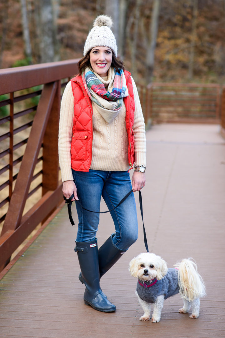 Jo-Lynne Shane wearing red J.Crew Excursion quilted down vest with ivory cable knit turtleneck sweater, DL1961 Emma legging jeans, Hunter classic rain boots, and plaid infinity scarf. #fashion #womensfashion #winteroutfit #hunterboots