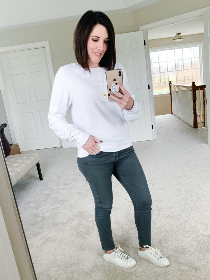 Jo-Lynne Shane wearing WILDFOX Clean White Sweatshirt with AG The Legging Ankle Jeans in Shadow Fog and UGG Milo Sneakers