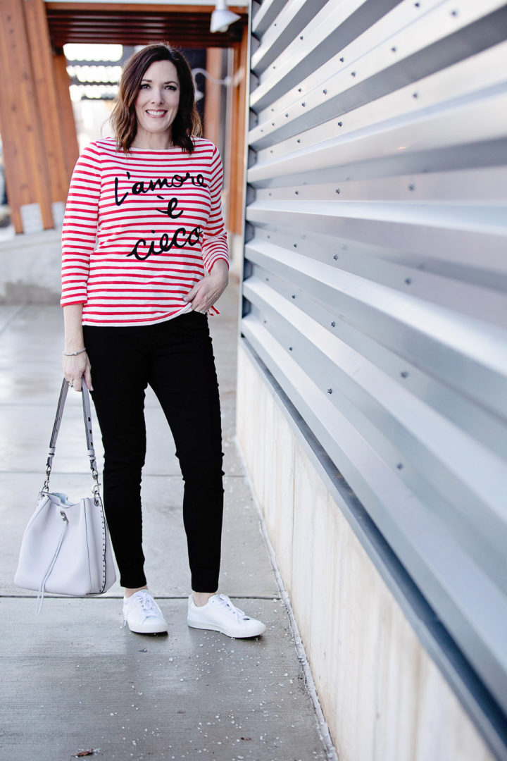 Jo-Lynne Shane wearing J.Crew "L'amore è cieco" Striped Boatneck T-shirt and 9" high-rise black skinny jeans w/ button fly with Veja Esplar Sneakers, R Minkoff Darren Shoulder Bag, and Lagos Signature Sterling Silver X Trio Caviar Bracelet