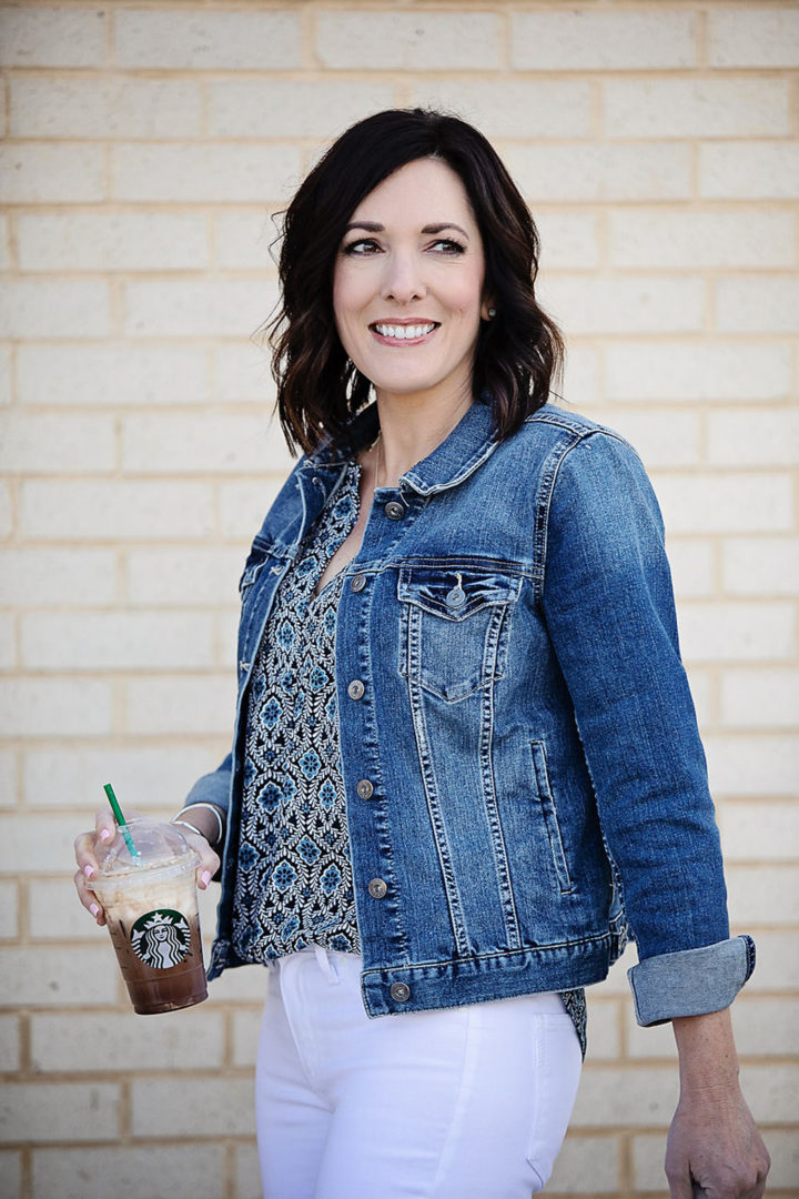 Jo-Lynne Shane wearing Two by Vince Camuto denim jacket with LOFT Geo Mixed Media Split Neck Shell, and Paige Verdugo white skinny jeans