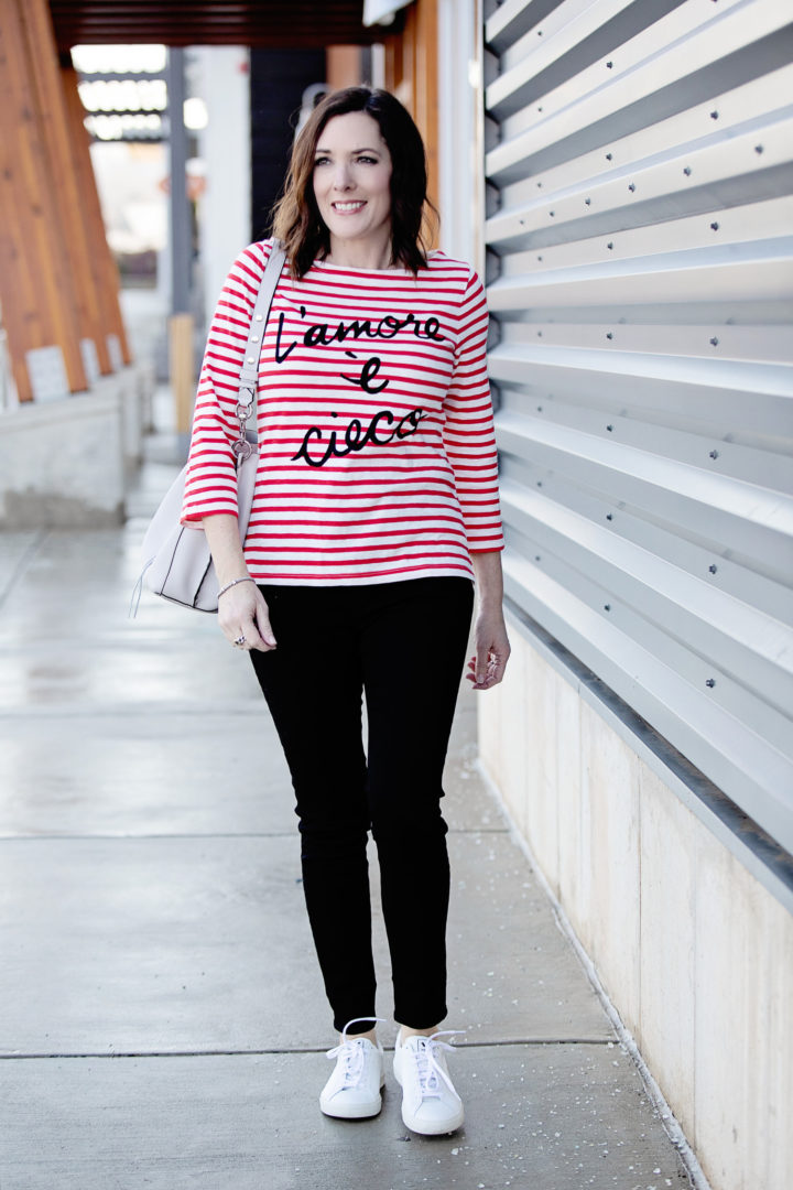Jo-Lynne Shane wearing J.Crew "L'amore è cieco" Striped Boatneck T-shirt and 9" high-rise black skinny jeans w/ button fly with Veja Esplar Sneakers, R Minkoff Darren Shoulder Bag, and Lagos Signature Sterling Silver X Trio Caviar Bracelet