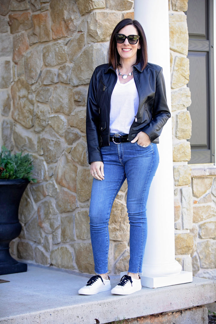 jeans and a white t-shirt with a black leather jacket and fashion sneakers