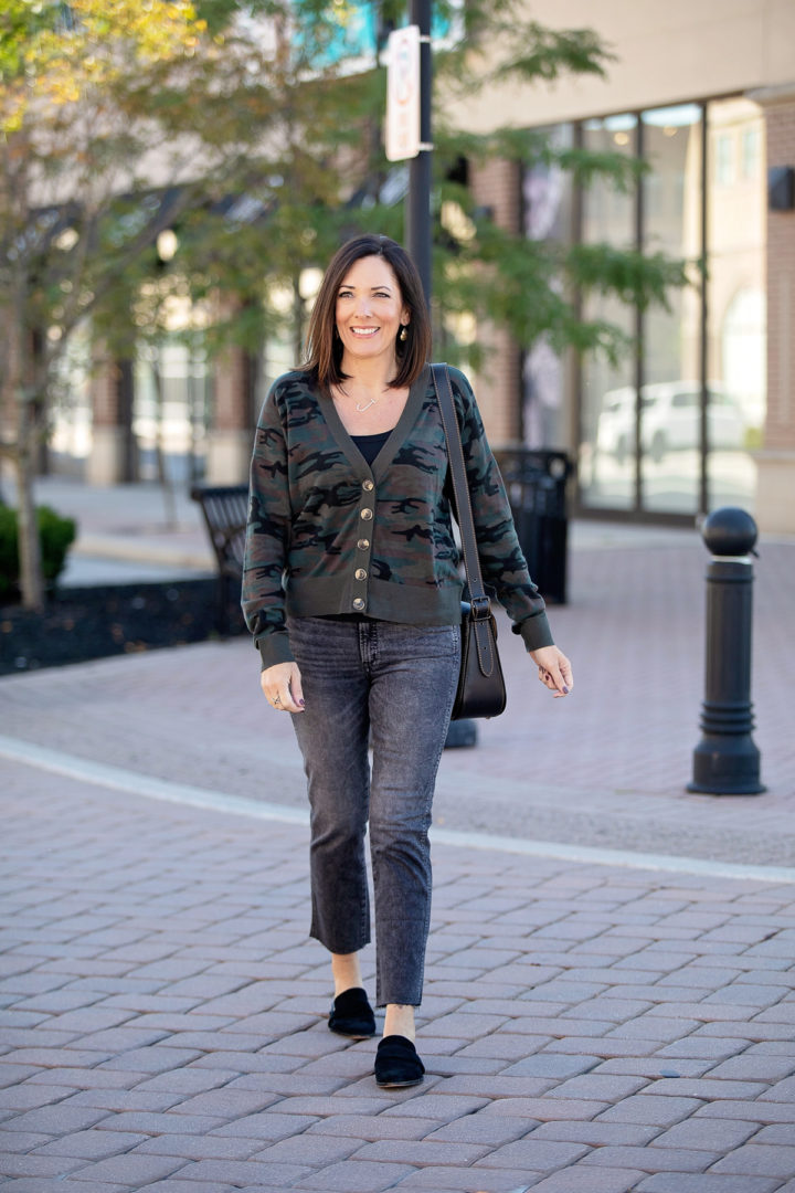 Jo-Lynne Shane wearing camo cardigan outfit for fall with washed black straight crop jeans and black suede mules