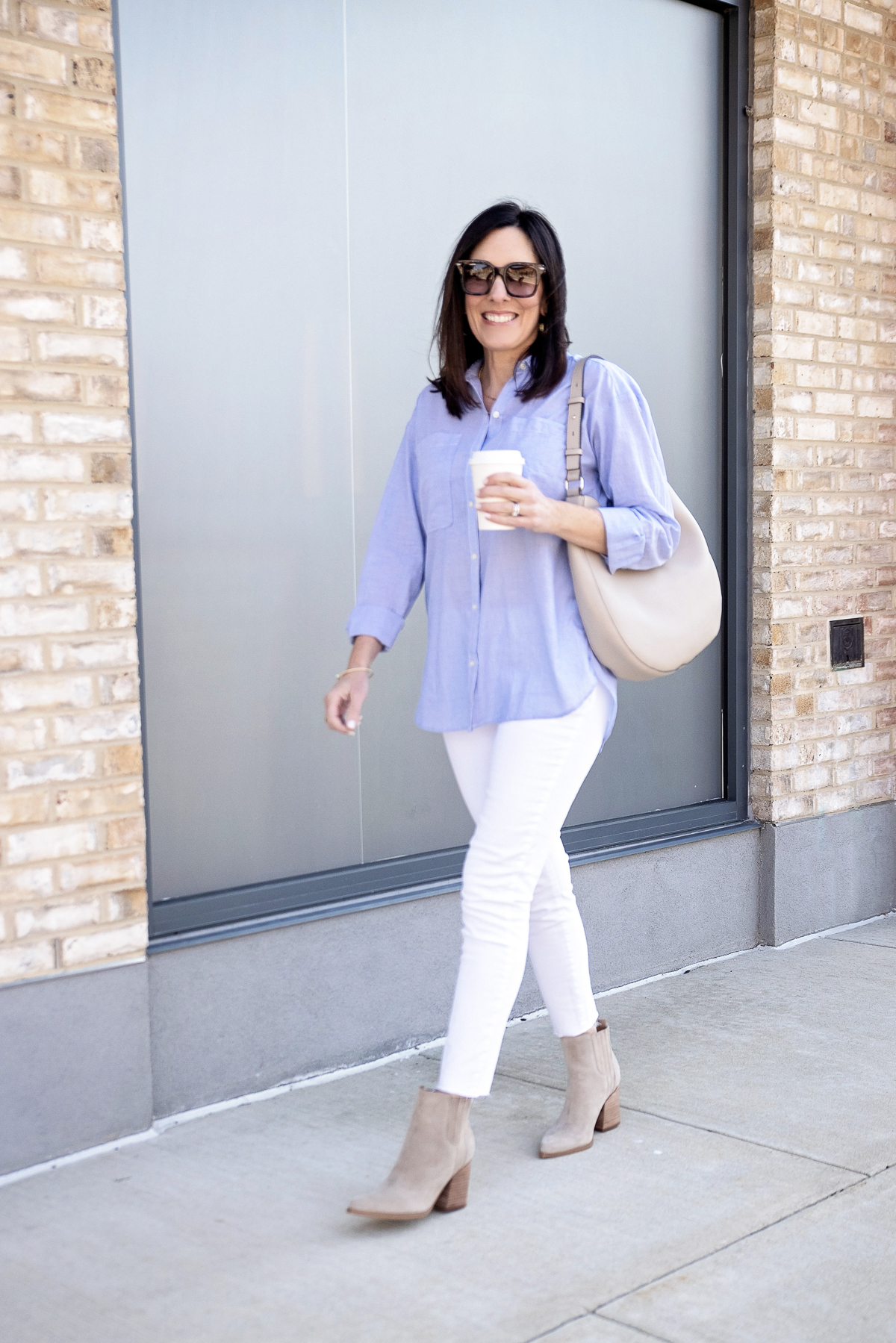 Jo-Lynne Shane styling an oversized button-up shirt with white jeans and booties for spring 2021