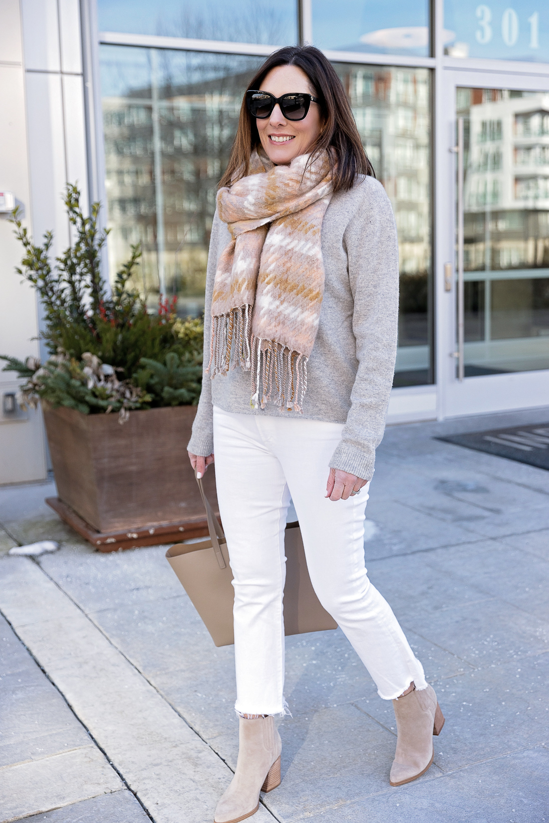 white jeans outfit for winter with scarf and ankle boots