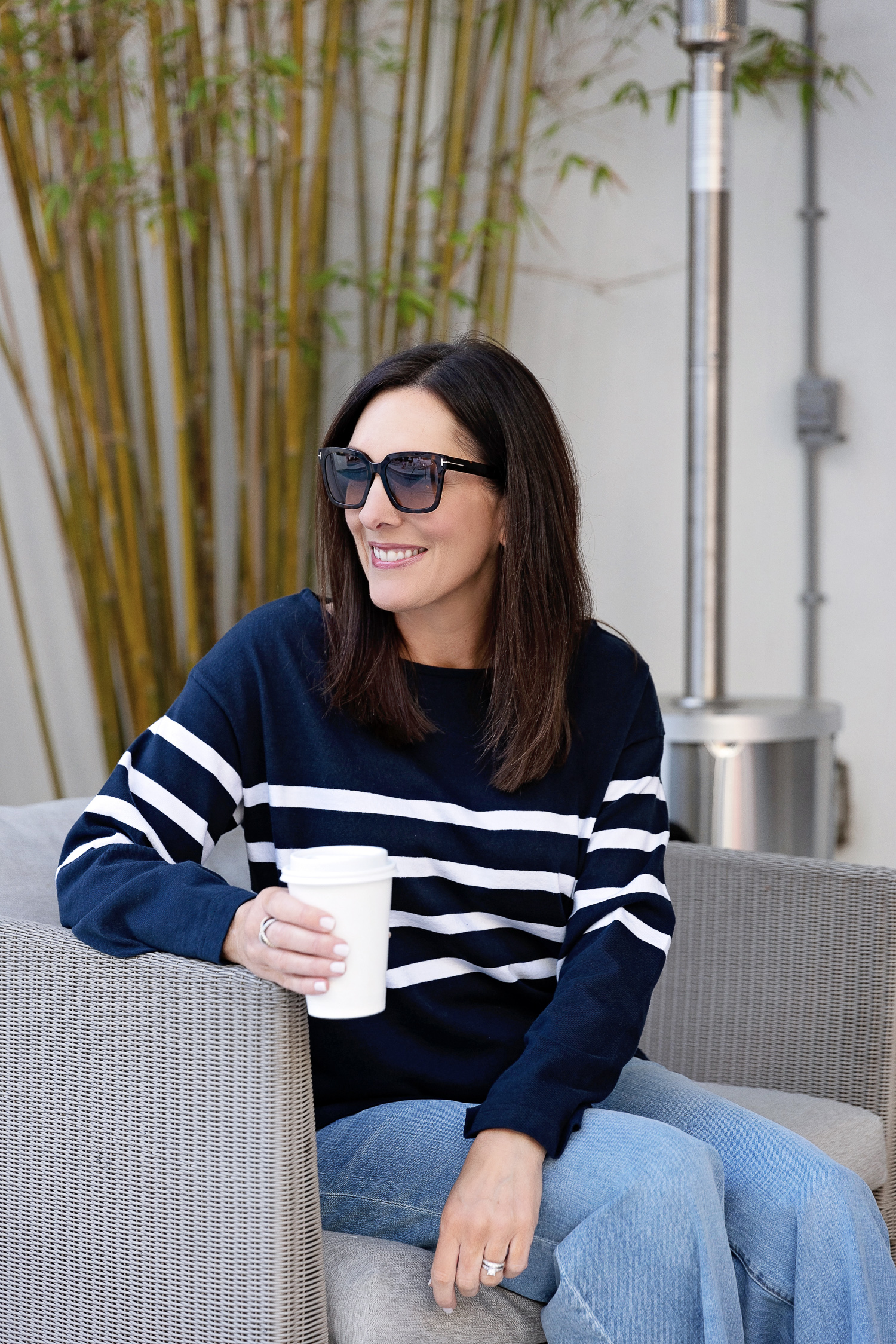 navy and white stripe top with blue jeans and coffee