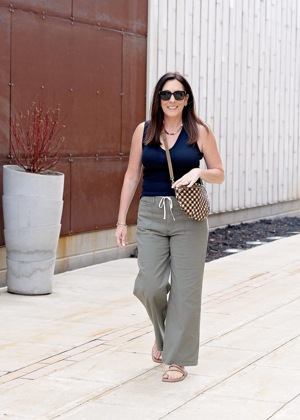 black tank and olive pants outfit circa 2026